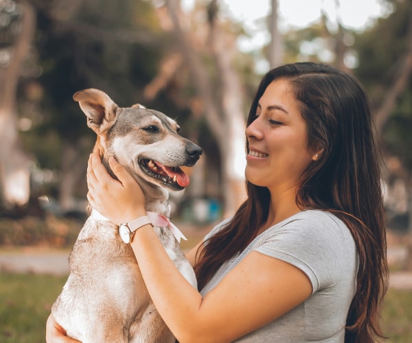 Happy girl with her happy pet dog