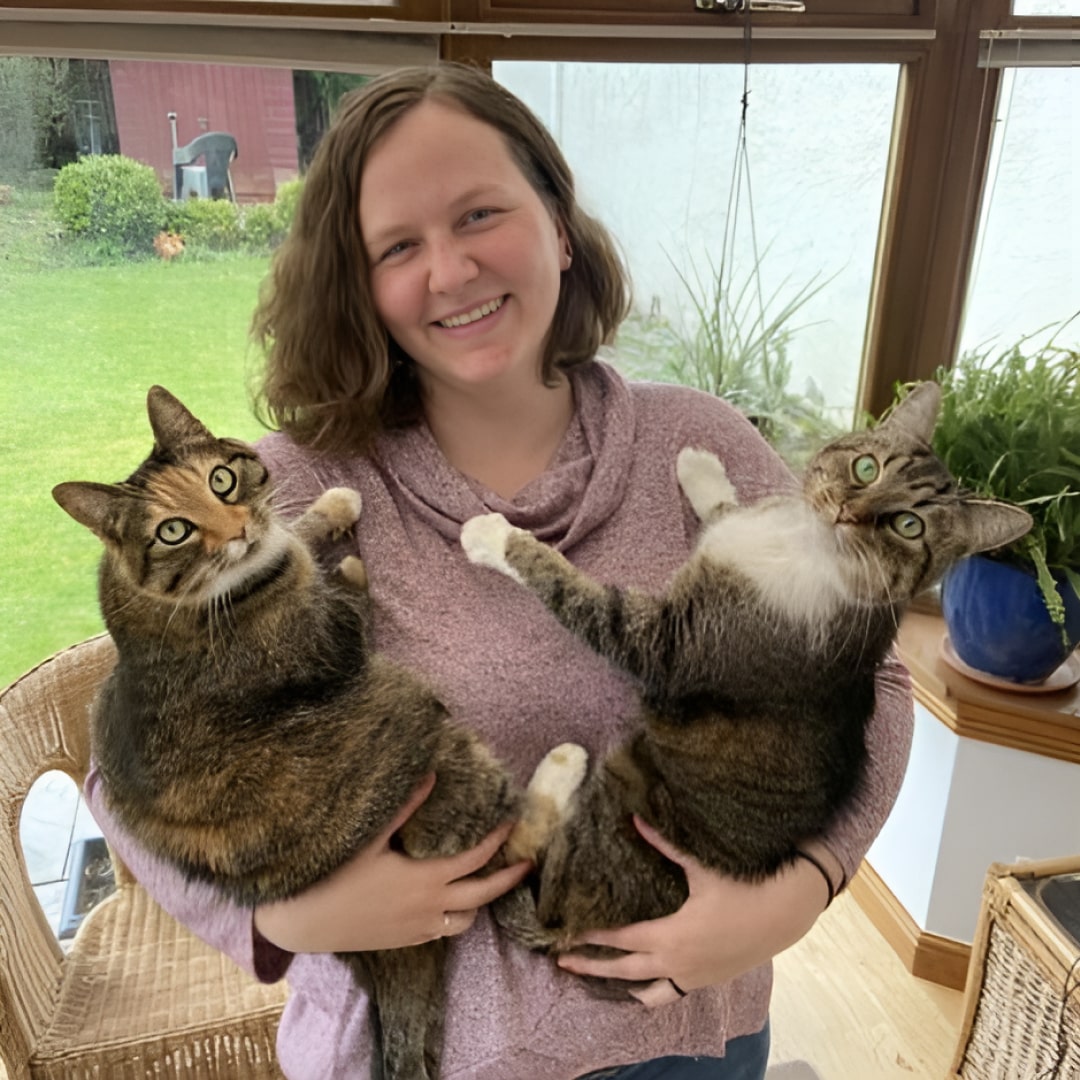 Dr, Myer holding two pet cats in her hands